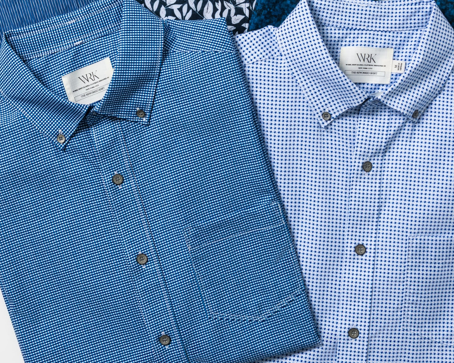 Collection of folded shirts in various patterns on a white background